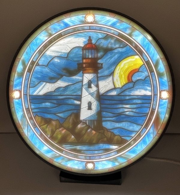 Stained glass lamp featuring lighthouse design with ocean and clouds, sunset in background, lighted from within.