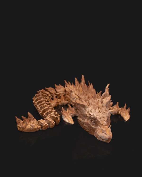 Articulated, poseable 3D printed dragon figure with intricate details displayed against a black background.