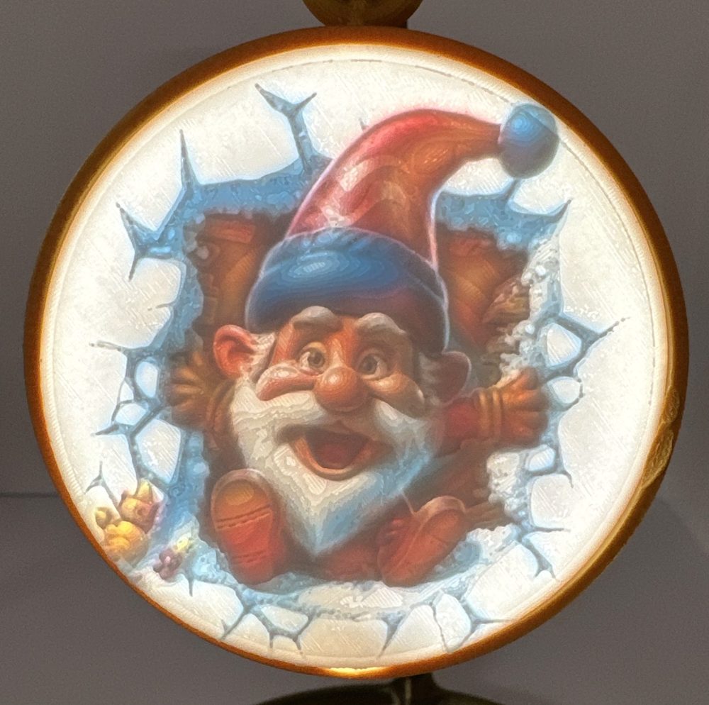 Round ornament featuring a jolly gnome in red hat framed by icy patterns.